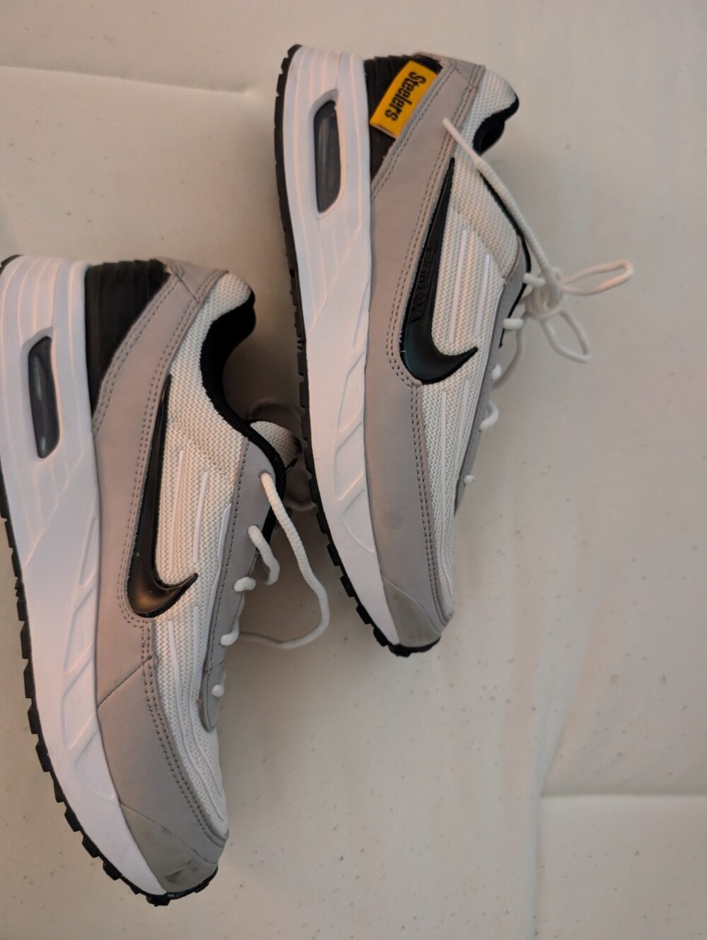 Unisex Nike Gray & White Athletic Sneakers with Black Swoosh